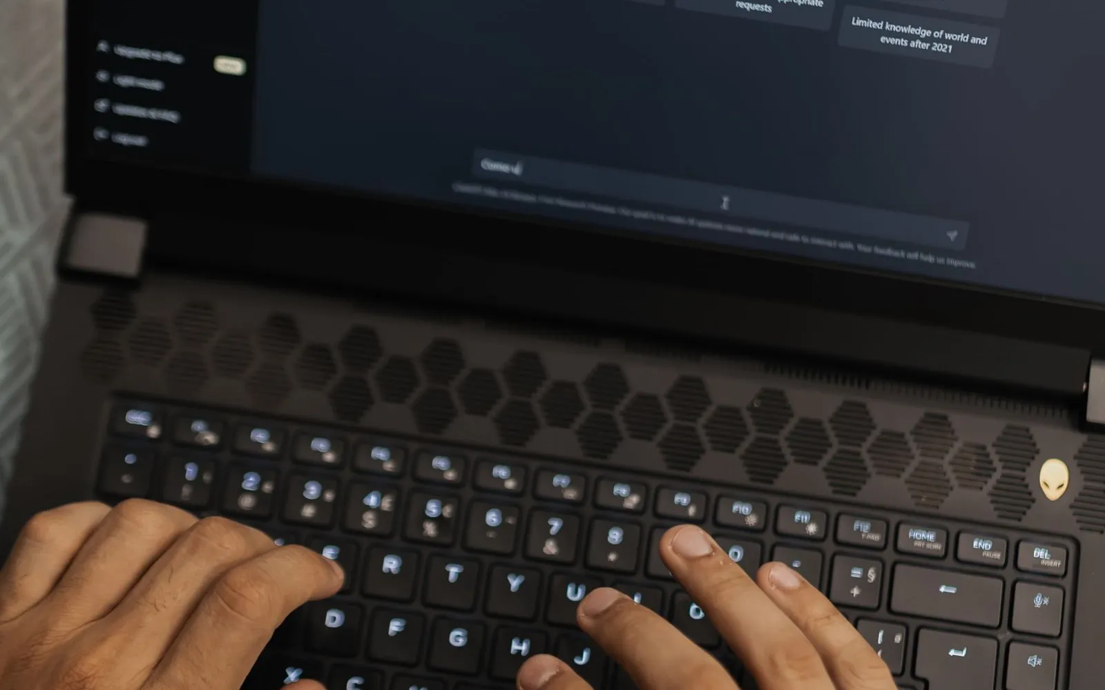 What is AI SEO – person typing a question into an AI assistant on a laptop