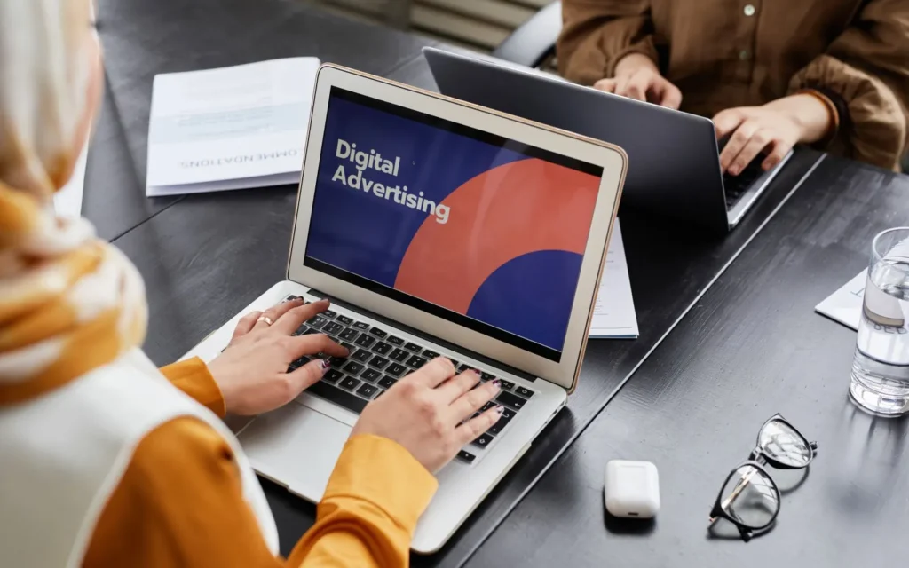 Marketers working on a digital advertising campaign on laptops