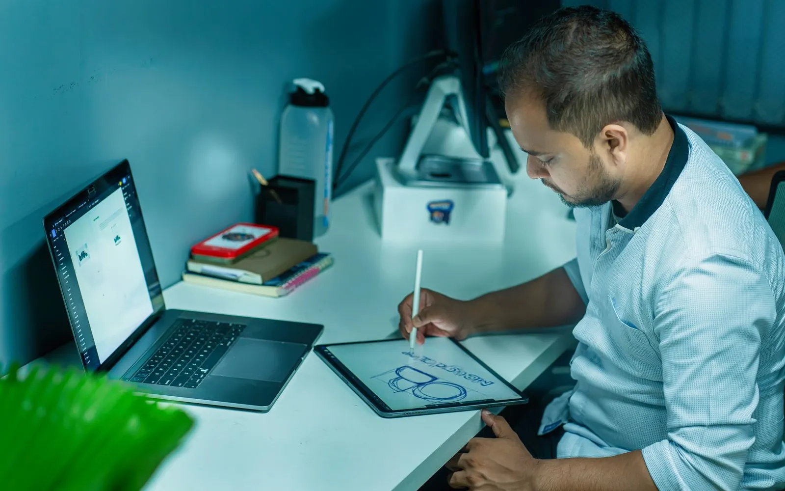 Graphic designing services in Kanpur – designer creating a logo on a drawing tablet