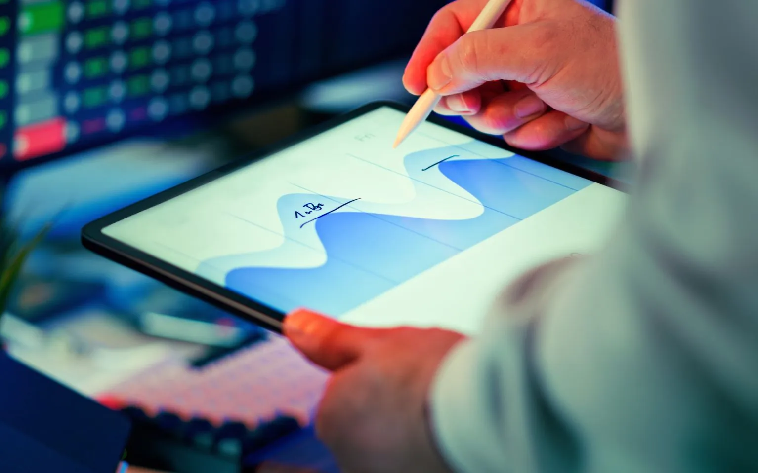 Analyst reviewing a performance chart on a tablet