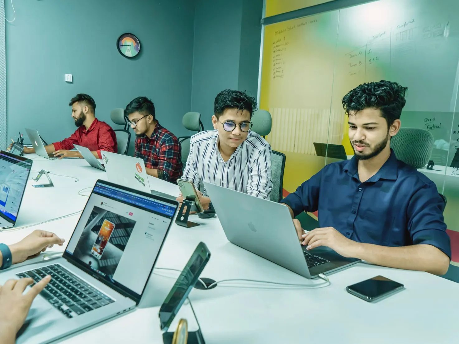 Digital marketing team working together on laptops