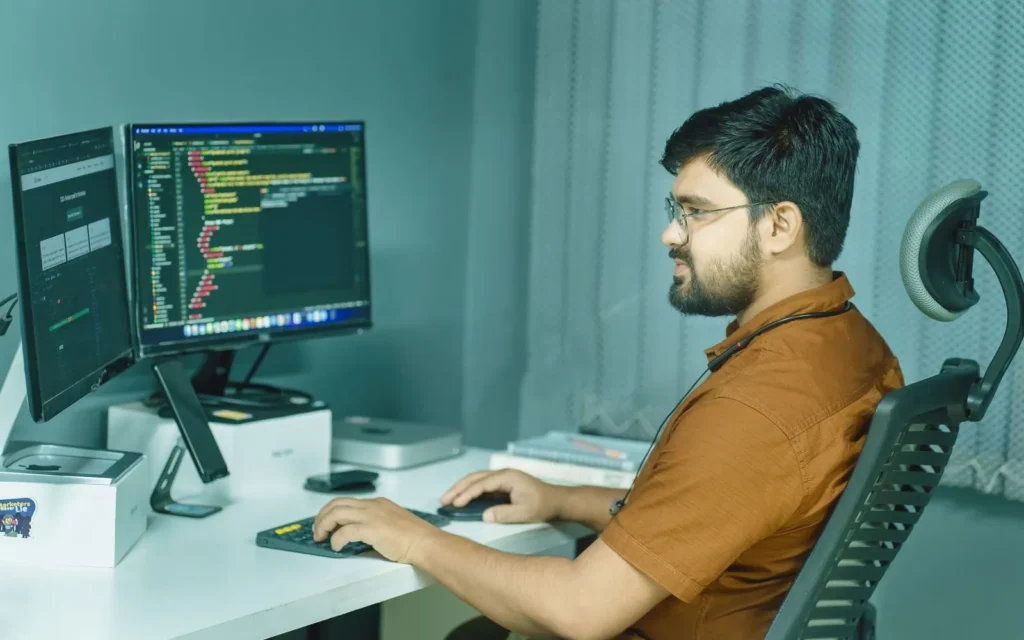 Web developer building a responsive website on dual monitors