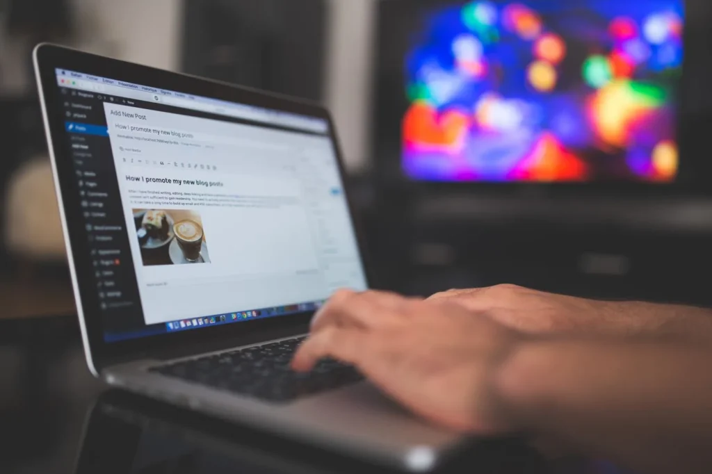 Editing a website page in a content management system on a laptop