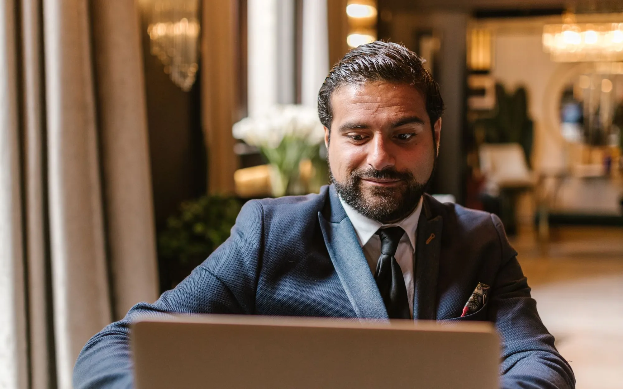 LinkedIn profile optimization services – professional updating his LinkedIn profile on a laptop
