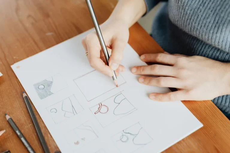 Designer sketching logo concepts with a pencil
