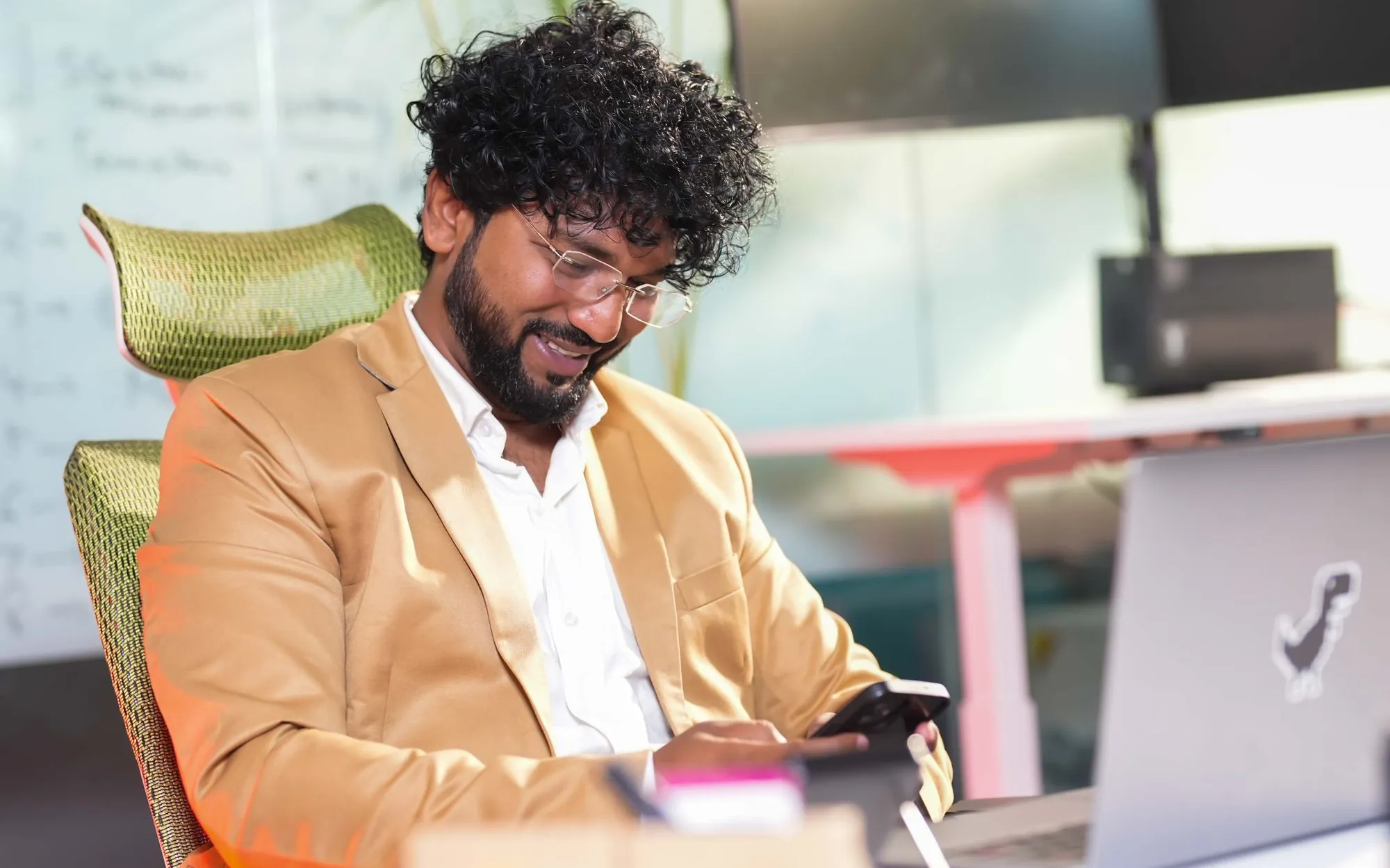 Personal branding on LinkedIn – professional checking LinkedIn on his phone at the office
