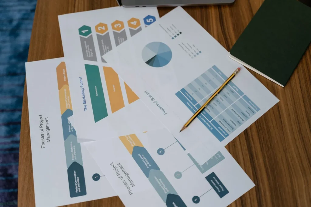 Campaign plans and performance charts on a desk